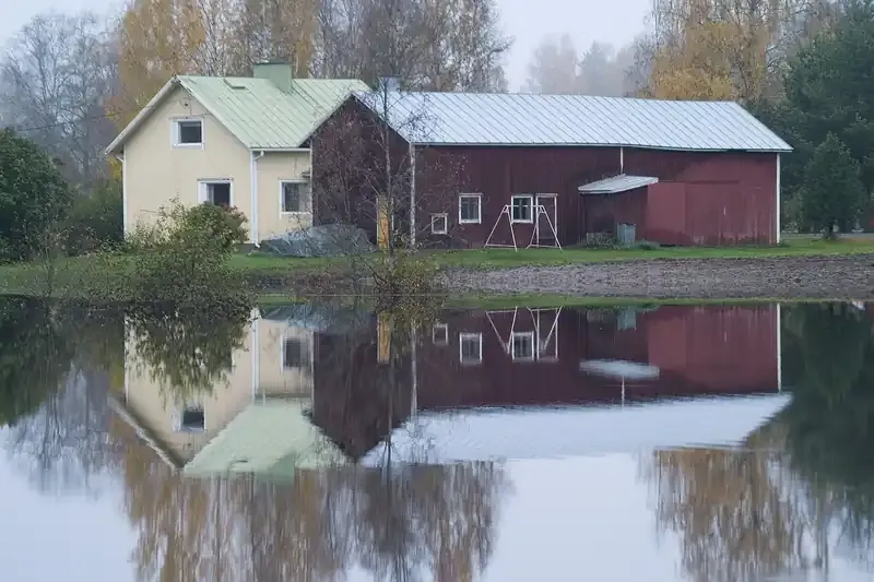 House and barn surrounded by standing floodwater